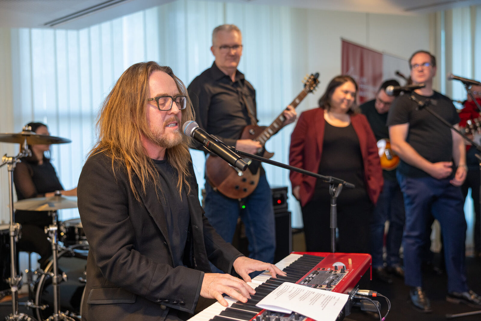 Tim Minchin performing at the keyboard with a live band at a Live Performance Australia event in Parliament House